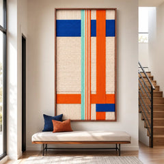 An entryway styled with the Midtown Rhythm hand-woven tapestry, creating a warm and welcoming atmosphere with its vibrant colors and clean lines.