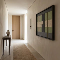 Vertical view of the Misty Forest fiber art hanging in a minimalist hallway with warm lighting and a neutral jute runner.