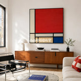 Mondrian red blue yellow and black textile wall art displayed above a walnut sideboard in a bright modern living room.