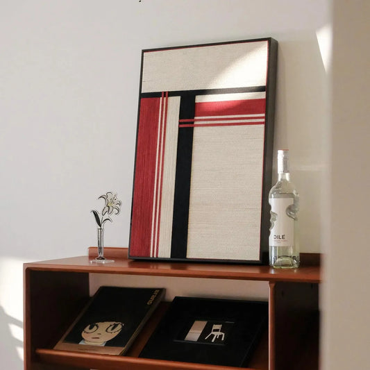 “Napoli” yarn wall art styled on a tabletop with minimal decor to emphasize its bold stripe pattern and precise square format
