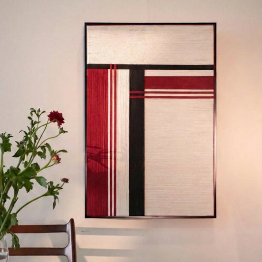 Napoli red, white and black geometric fiber wall art displayed on a light wall beside flowers