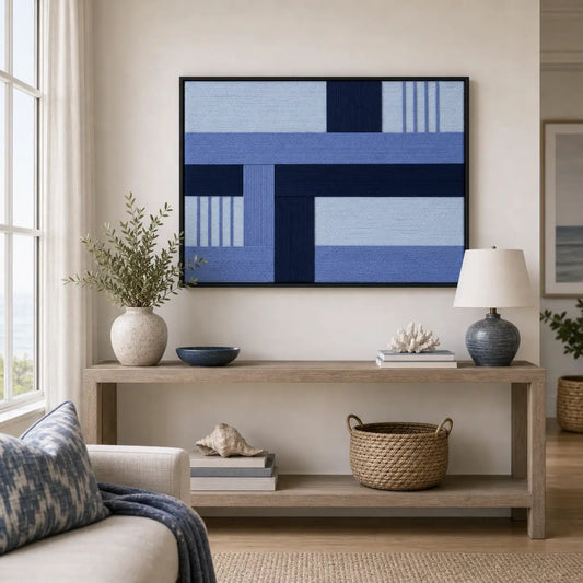 Framed Nordic Tide hand-woven wall art displayed above a light wood console table in a serene, neutral-toned living room setting.