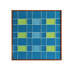 Studio front view of the hand-woven wool wall art featuring a geometric checkerboard pattern in shades of deep ocean blue and bright green.