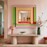 Olive Tree Romance green, blush, beige, orange, and red yarn-framed mirror displayed above a sculptural console in a bright entryway.