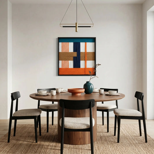Modern orange and navy fiber wall art styled in a contemporary dining room with a round wooden table and minimalist chairs.