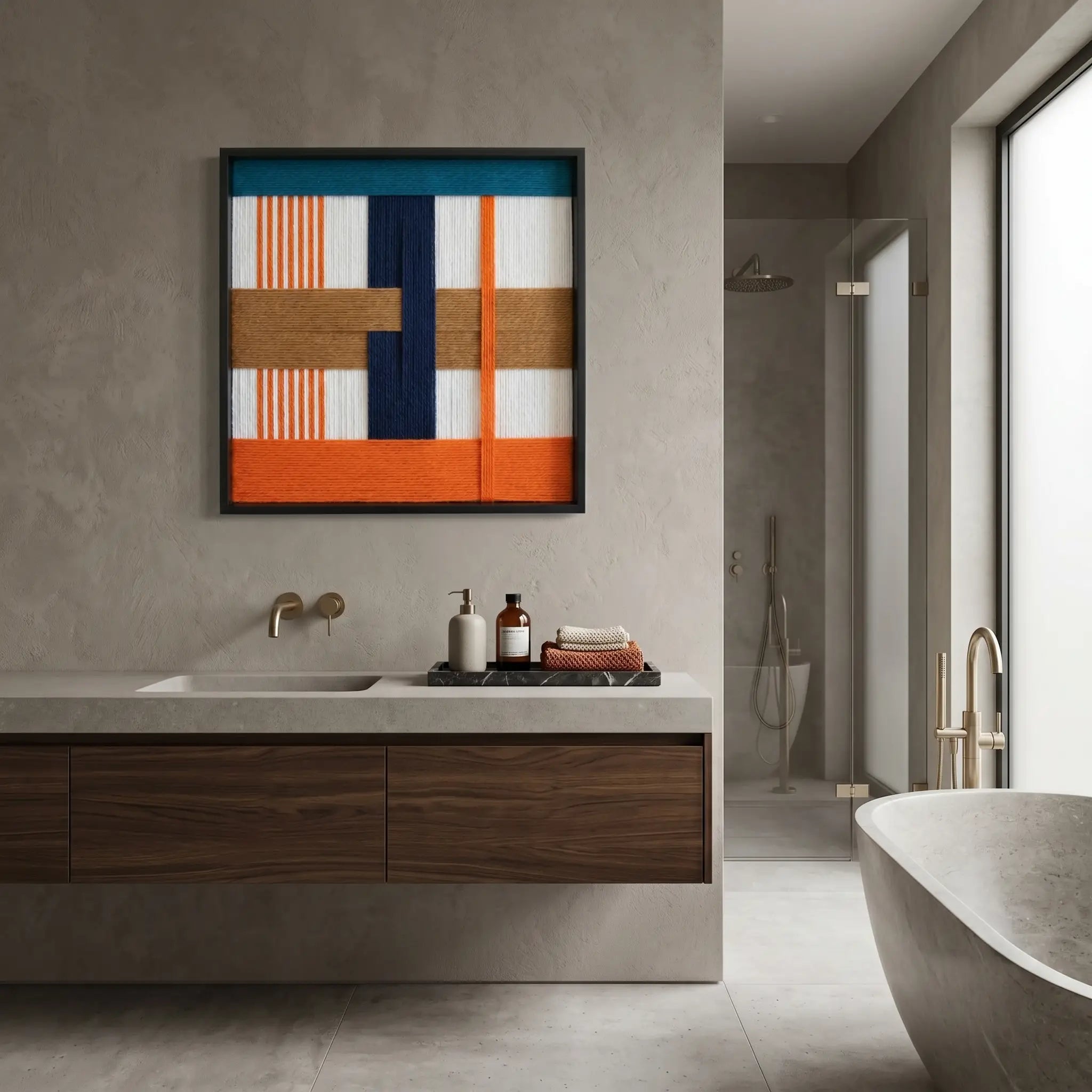 Textured fiber art piece displayed in a high-end minimalist bathroom above a walnut vanity and freestanding bathtub.
