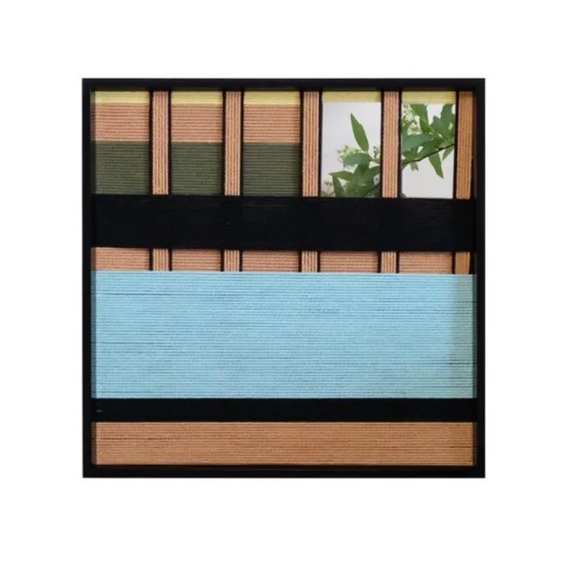 Close-up of Outside The Window wool yarn art showing tight weave detail and color contrast between soft blue panel and earth-tone stripes.
