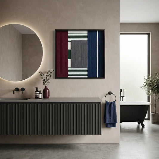 Modern textured wool wall art displayed in a luxury bathroom above a dark floating vanity with a backlit circular mirror.