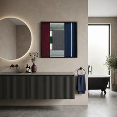 Modern textured wool wall art displayed in a luxury bathroom above a dark floating vanity with a backlit circular mirror.