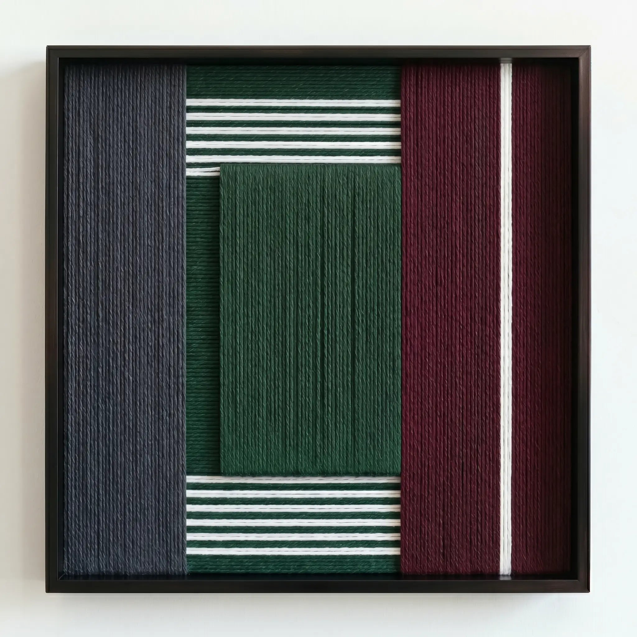 Frontal studio shot of the textured fiber wall art variant featuring a central forest green wool block with striped accents.
