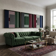 A striking trio of Overture of Dusk & Dawn hand-woven textile wall art pieces hanging together above a plush emerald green velvet sofa in a modern living space.