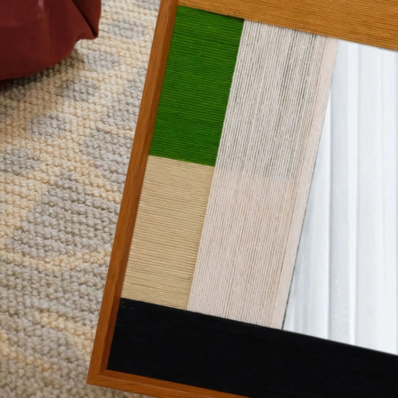 Close-up of Pastoral Elegance yarn wall art revealing looped wool texture and clean transitions between emerald and beige panels
