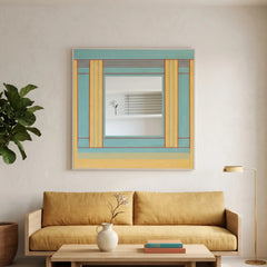 Large hand-woven wool wall art with teal and yellow geometric patterns hanging above a modern yellow sofa in a minimalist living room.