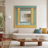 Pear Blossom Tree aqua, golden yellow, and rust yarn-framed mirror displayed above a cream sofa in a bright modern living room.