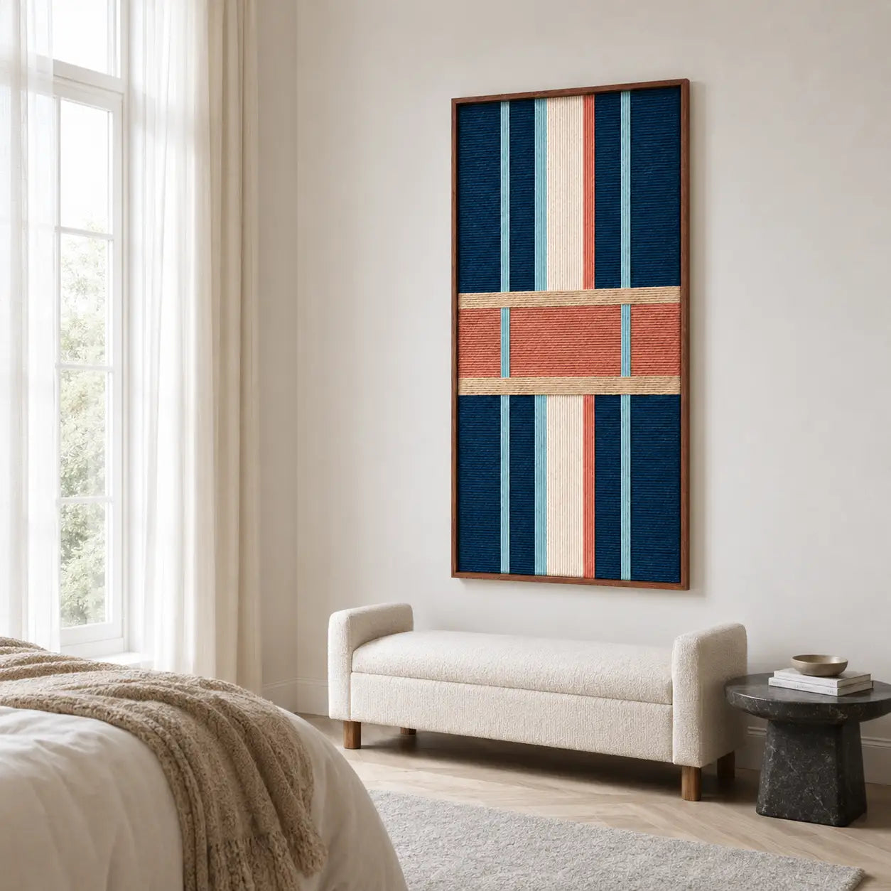 Cozy modern bedroom interior styling with the vertical hand-woven wool tapestry displayed centrally above a neutral bench and textured area rug.