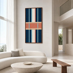 Spacious modern living room decor displaying the geometric hand-woven wool tapestry mounted on a clean white wall near a curved sofa and coffee table.