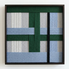 Frontal studio shot of the "Polar Forest" hand-woven wool wall art in a square black frame against a clean white background.