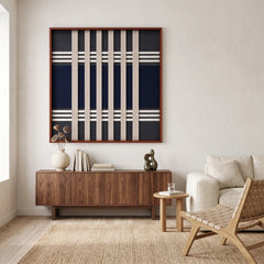 Framed Polar Meridian textile wall art styled elegantly above a dark wood sideboard in a sunlit modern living room setting.