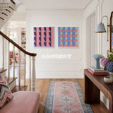 Framed Whispering Bricks soft cotton cord wall art with pink bands and purple-blue triangles in a refined room.