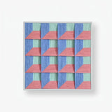 Whispering Bricks framed textile artwork featuring layered pink bands over a precise purple and muted blue triangular pattern.