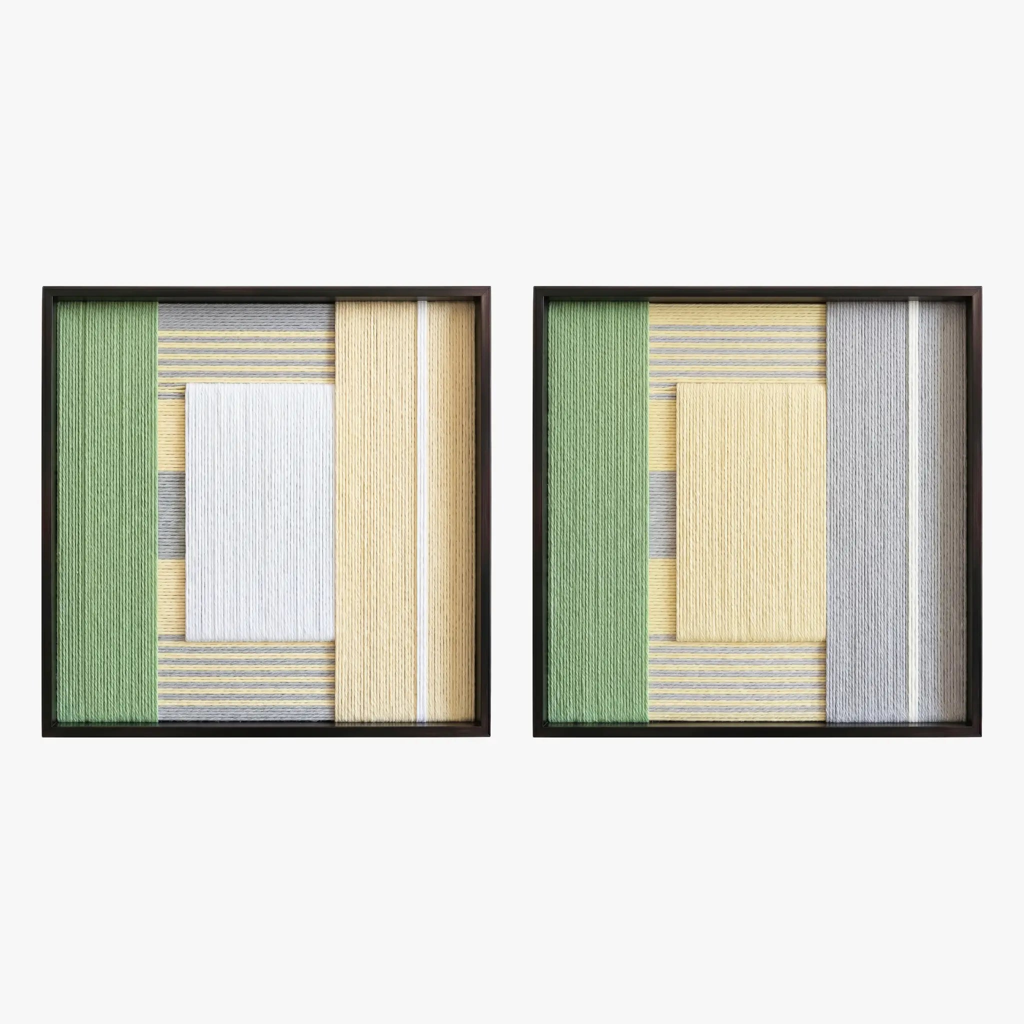 Front studio view of the Sun-Baked textile art pair with yellow, white, and sage green geometric designs in black frames on a white background.