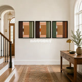 Framed Sylvan Glow textile wall art with army green, citrus orange, umber, and sand blocks in a refined room.