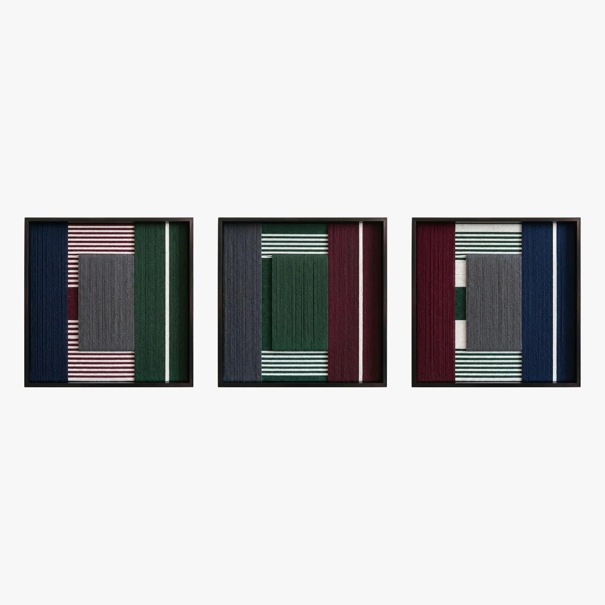 Front studio view of the Overture of Dusk and Dawn triptych with three square textured textile artworks in black frames.