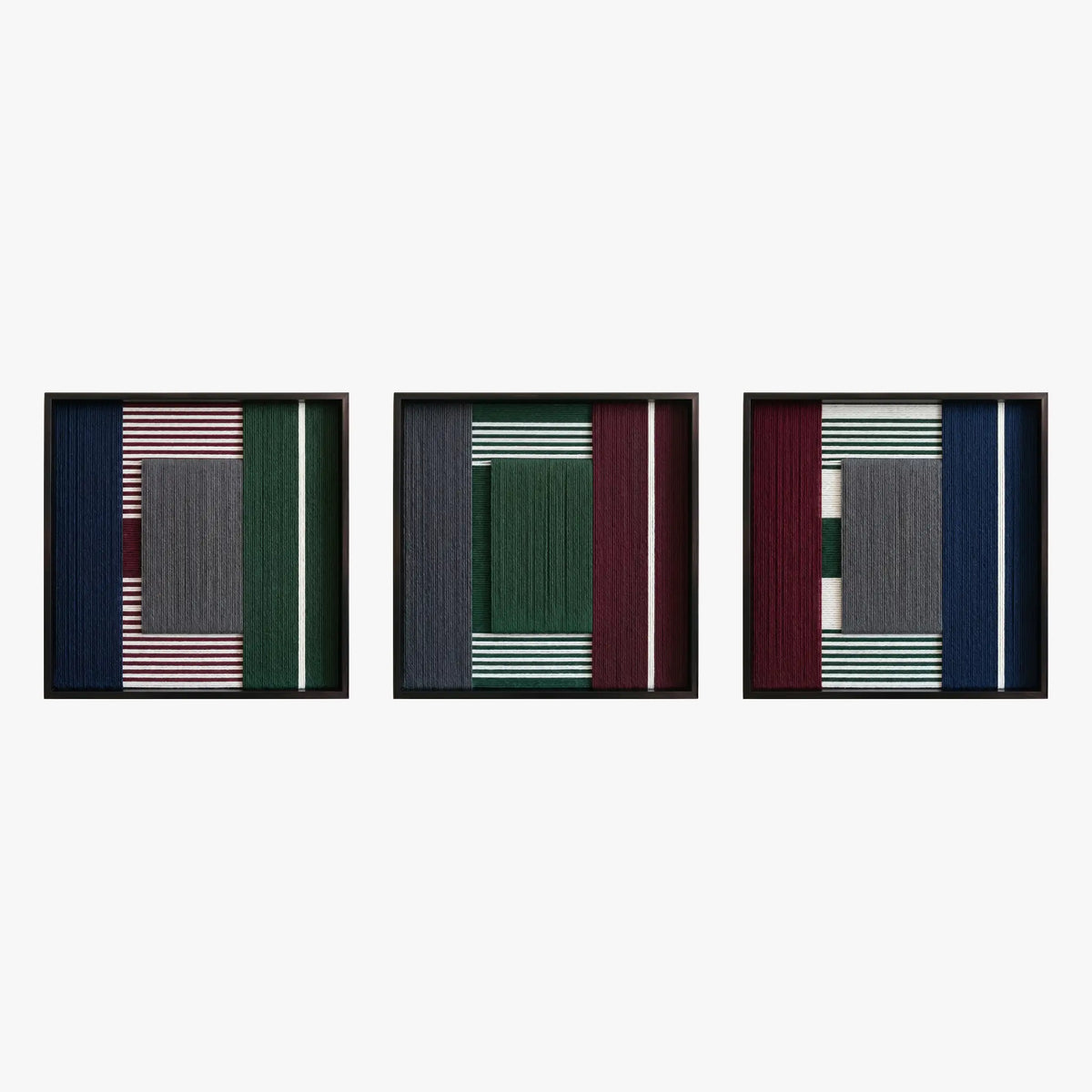 Front studio view of the Overture of Dusk and Dawn triptych with three square textured textile artworks in black frames.