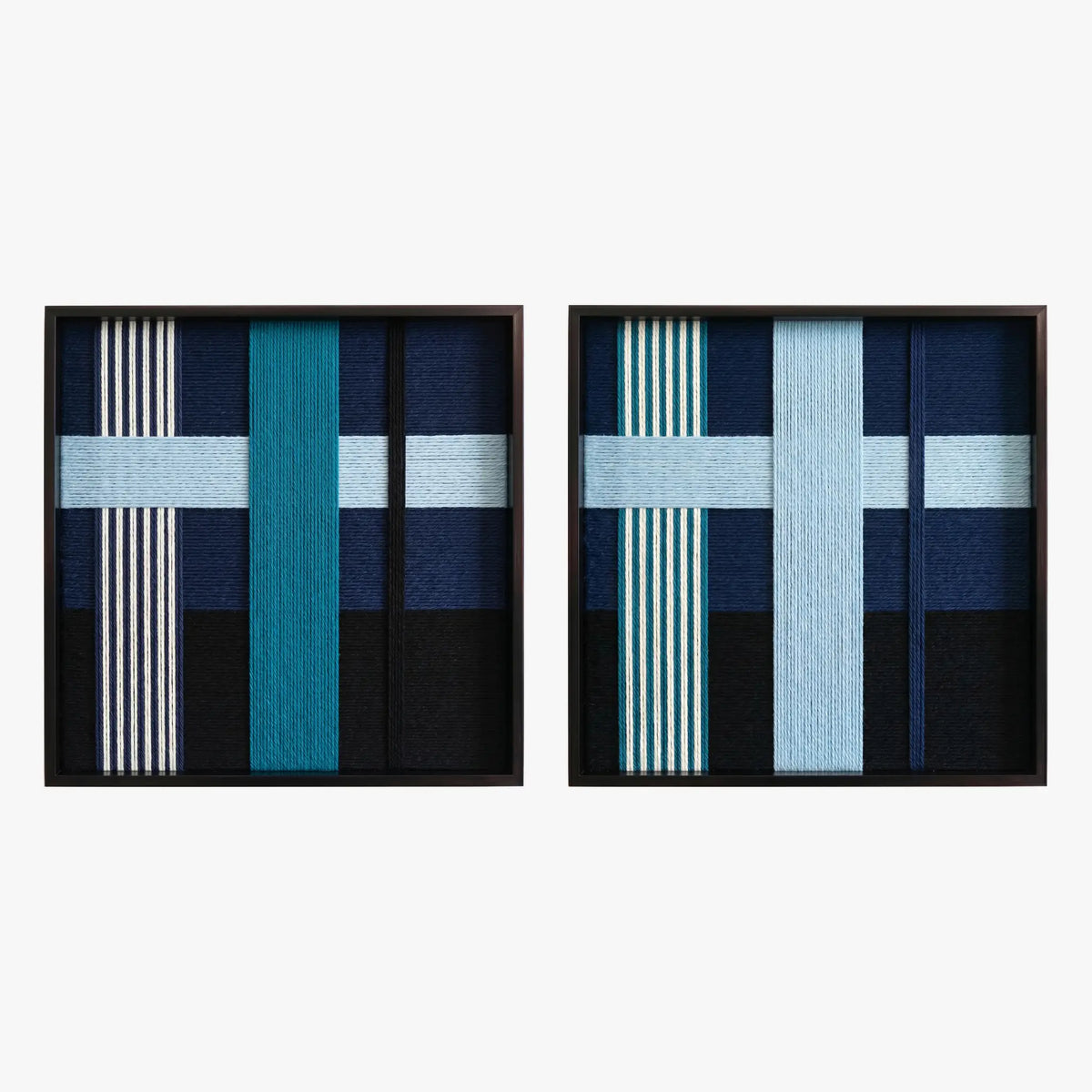 Front studio view of the Glacial Stationeries textile art pair with icy blue and navy geometric designs in black frames on a white background.