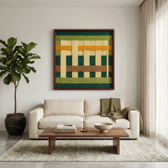 Modern hand-woven wool wall hanging styled in a bright living room above a cream sofa with a wooden coffee table and rug.