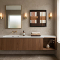 Large square hand-woven wool wall art in earth tones displayed in a modern luxury bathroom above a floating walnut vanity.