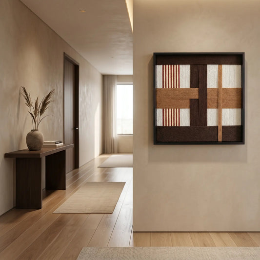 Textured wool wall art creating a sophisticated focal point in a minimalist entryway with light oak flooring and neutral walls.