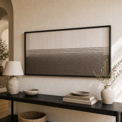 Striking hand-woven wool tapestry positioned perfectly above a sleek dark console table adorned with modern decor.