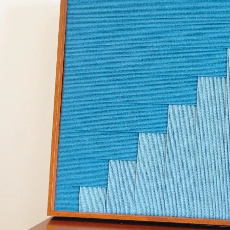 Detail shot showing smooth gradient transitions from light sky blue to deep azure across woven panels
