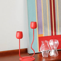 Rainbow Hearts yarn art displayed on a bookshelf alongside decorative books and a heart accent, emphasizing its vibrant stripe composition
