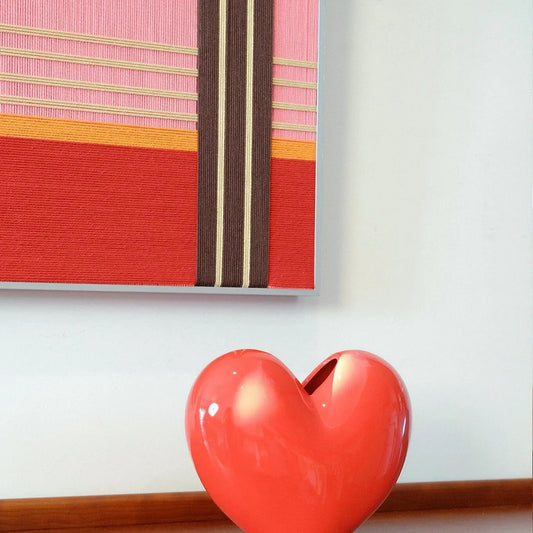 Close-up of Rainbow Hearts RE005 textile art showing dense soft cotton cord texture and crisp transitions between colorful geometric panels.