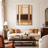 Rohmer RE014 framed textile art with dark brown, creamy yellow, blush tan, and cream geometric yarn layers displayed in a mid-century interior.