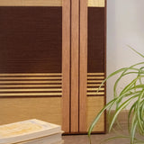 Close-up of Rohmer RE014 textile art showing layered brown, tan, and cream soft cotton cord lines beside a green plant.