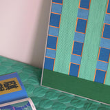 Endless Summer in Hawaii RE017 vertical textile wall art displayed on a teal bedspread in a relaxed summer setting.