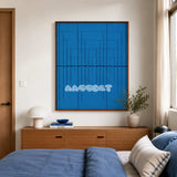 Submersion RE018 cerulean blue geometric textile wall art displayed above a wood dresser in a bright modern bedroom.