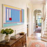 Summer Letter RE019 framed fiber artwork featuring a blue center, multicolor linear bands, and a bold red square in a modern interior.