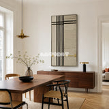 The Monologue RE020 framed fiber artwork featuring bold black vertical lines, cream textured panels, and an ochre gold detail.