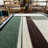 Low-angle studio view of Forest Ruins RE022 textile art highlighting its rich soft cotton cord texture and precise geometric layering.