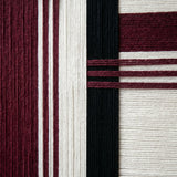 Macro close-up of Midnight Opera RE025 textile art highlighting rich burgundy and black soft cotton cord textures.
