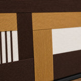 Macro close-up of Cocoa Loom RE029 textile art highlighting thick brown, beige, and white intersecting soft cotton cord textures.