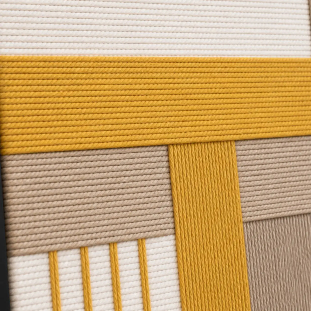 Macro close-up of Golden Interval RE030 textile art highlighting thick mustard yellow and beige soft cotton cord texture.