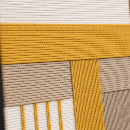 Macro close-up of Golden Interval RE030 textile art highlighting thick mustard yellow and beige soft cotton cord texture.