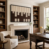 Framed Ivory Loom woven wall hanging featuring cream and dark brown geometric bands in a refined room.