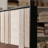 Angled detail of the black frame and dimensional cream and brown soft cotton cord patterns of Ivory Rhythm textile art.