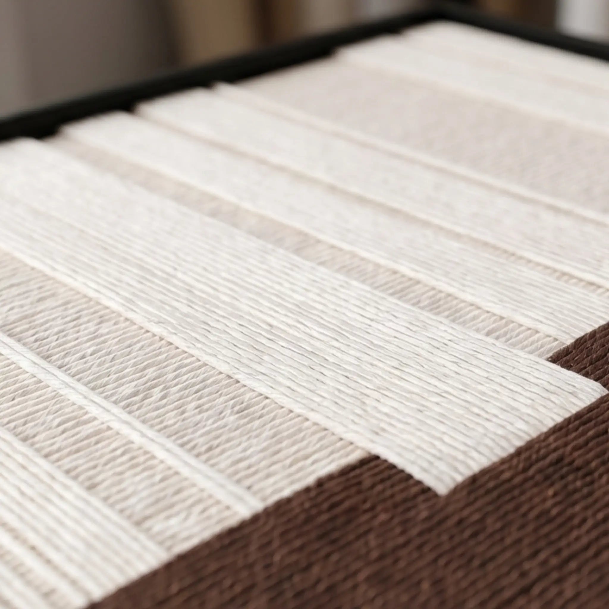 Angled macro detail of Ivory Rhythm textile art showing raised cream vertical yarn over a textured brown base.